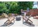 A cozy outdoor patio with a fire pit and comfortable seating creates the perfect gathering space at 216 Commodore Ct, Belmont, NC 28012