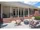 Enjoy outdoor living on this covered patio with brick accents and comfortable seating arrangements at 216 Commodore Ct, Belmont, NC 28012