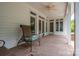 The covered patio with brick flooring and ceiling fan offers a comfortable outdoor retreat at 216 Commodore Ct, Belmont, NC 28012