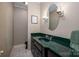 Stylish powder room with a dark vanity, green marble countertop, and decorative mirror at 216 Commodore Ct, Belmont, NC 28012