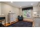 Sitting room features hardwood floors, natural light, black-out curtains, and large area rug at 216 Commodore Ct, Belmont, NC 28012
