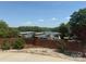 Picturesque view of the lake and the marina from behind a decorative brick wall and landscaping at 216 Commodore Ct, Belmont, NC 28012