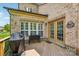 Brick home with a wooden deck featuring a grill, seating, and direct access to the yard at 2254 Donnington Nw Ln, Concord, NC 28027