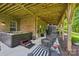 Covered back patio with a hot tub, outdoor seating, and string lights for ambiance at 2254 Donnington Nw Ln, Concord, NC 28027