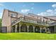 Large backyard with a covered deck, patio, and a well-maintained lawn at 2254 Donnington Nw Ln, Concord, NC 28027