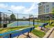 Outdoor basketball court with blue surface, surrounded by black chain-link fence, next to a modern building at 2254 Donnington Nw Ln, Concord, NC 28027