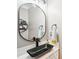 Modern bathroom features sleek black faucet and unique vessel sink atop a white countertop at 2254 Donnington Nw Ln, Concord, NC 28027