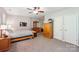 Cozy bedroom with a ceiling fan, carpet flooring, and natural wood furniture at 2254 Donnington Nw Ln, Concord, NC 28027