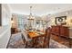 Elegant dining room features a hardwood floor, a chandelier, and a dining table set for a formal dinner at 2254 Donnington Nw Ln, Concord, NC 28027