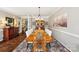 Sophisticated dining room featuring a large dining table, hardwood floors, and a decorative china cabinet at 2254 Donnington Nw Ln, Concord, NC 28027