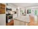 Bright kitchen with stainless steel appliances, white cabinets, and granite countertops at 2254 Donnington Nw Ln, Concord, NC 28027