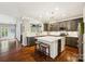 Contemporary kitchen with an island, stainless steel appliances, gray cabinetry, and hardwood floors throughout at 2254 Donnington Nw Ln, Concord, NC 28027