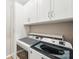 Bright laundry room features modern washer and dryer with white cabinets at 2254 Donnington Nw Ln, Concord, NC 28027