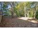 The backyard boasts ample space with mature trees, creating a serene retreat at 2643 Rolling Hills Dr, Monroe, NC 28110