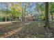 The home features a brick exterior, multilevel deck, and a backyard full of mature trees at 2643 Rolling Hills Dr, Monroe, NC 28110