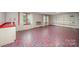 Basement with a patterned floor, utility sink, bright windows, and built in white shelves at 2643 Rolling Hills Dr, Monroe, NC 28110