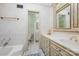 Bright bathroom featuring a tub, tiled floors, and cream-colored cabinets and a doorway leading to another full bath at 2643 Rolling Hills Dr, Monroe, NC 28110