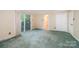 Spacious bedroom featuring large sliding glass door, carpet flooring, and access to a bathroom at 2643 Rolling Hills Dr, Monroe, NC 28110