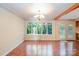 Bright dining room with terra cotta tile flooring, large windows and french doors at 2643 Rolling Hills Dr, Monroe, NC 28110