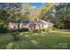Lovely single-story brick home with green lawn, surrounded by mature trees at 2643 Rolling Hills Dr, Monroe, NC 28110
