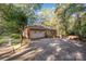 Exterior shot of the garage with a driveway and tree lined front yard at 2643 Rolling Hills Dr, Monroe, NC 28110