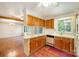 Kitchen area with wood cabinets, stainless steel appliances, and brick flooring at 2643 Rolling Hills Dr, Monroe, NC 28110