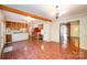 Eat-in kitchen with wood cabinets, brick floor, and view to the front door at 2643 Rolling Hills Dr, Monroe, NC 28110