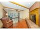 Open living room with hardwood floors, exposed beam ceiling, and fireplace at 2643 Rolling Hills Dr, Monroe, NC 28110