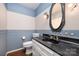 Charming powder room featuring cat-themed wallpaper, a dark countertop, and stylish light fixtures at 2643 Rolling Hills Dr, Monroe, NC 28110