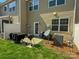 Cozy back patio featuring a grill, outdoor seating, and access to the backyard at 2752 Sawbridge Ln, Gastonia, NC 28056