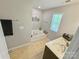Bright bathroom featuring a soaking tub, window, and a single sink vanity at 2752 Sawbridge Ln, Gastonia, NC 28056