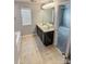 Spacious bathroom featuring dual sinks with a large mirror and tile flooring, offering functionality and style at 2752 Sawbridge Ln, Gastonia, NC 28056