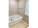 Clean bathroom featuring a tub, complemented by neutral paint and tile flooring at 2752 Sawbridge Ln, Gastonia, NC 28056