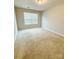 Bright bedroom featuring neutral walls, carpet flooring, and a large window providing ample natural light at 2752 Sawbridge Ln, Gastonia, NC 28056