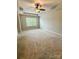 Bright bedroom featuring neutral walls, carpet flooring, a ceiling fan, and a large window providing ample natural light at 2752 Sawbridge Ln, Gastonia, NC 28056