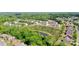 Aerial view of a residential community with lush greenery and pond at 2752 Sawbridge Ln, Gastonia, NC 28056