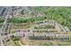Aerial view of community with lush landscaping, walking trails, and a tranquil pond at 2752 Sawbridge Ln, Gastonia, NC 28056