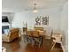 Bright dining room with wooden table, four chairs, and modern artwork on the wall at 2752 Sawbridge Ln, Gastonia, NC 28056