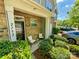 Inviting front porch with outdoor seating, brick facade, and lush landscaping surrounding the entrance at 2752 Sawbridge Ln, Gastonia, NC 28056