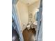 Cozy half bathroom with stylish pedestal sink, round mirror, and hardwood floors at 2752 Sawbridge Ln, Gastonia, NC 28056