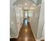 Inviting hallway featuring hardwood floors, neutral walls, and multiple doors leading to various rooms at 2752 Sawbridge Ln, Gastonia, NC 28056