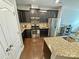 Modern kitchen featuring granite countertops, stainless steel appliances, and sleek dark cabinetry at 2752 Sawbridge Ln, Gastonia, NC 28056