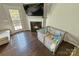 Cozy living room featuring a modern fireplace, hardwood floors, and a glass door to the exterior at 2752 Sawbridge Ln, Gastonia, NC 28056