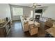 Bright living room with hardwood floors, a fireplace, a ceiling fan, and a large window at 2752 Sawbridge Ln, Gastonia, NC 28056