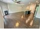Open-concept kitchen and living area with hardwood floors and fireplace at 2752 Sawbridge Ln, Gastonia, NC 28056