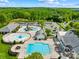 Aerial shot showcasing neighborhood pool, slides, parking, and clubhouse nestled among trees at 3022 Oakmere Rd, Waxhaw, NC 28173