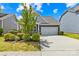Attractive home showcasing a two-car garage, well-maintained lawn and landscaping, and lovely curb appeal at 3022 Oakmere Rd, Waxhaw, NC 28173