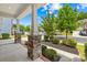 Inviting porch with stone-based columns, manicured landscaping, and a picturesque view of the neighborhood street at 3022 Oakmere Rd, Waxhaw, NC 28173