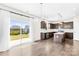 Gourmet kitchen with stainless steel appliances, granite countertops, and island, adjacent to outdoor patio at 3022 Oakmere Rd, Waxhaw, NC 28173