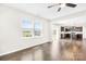 Bright living room with hardwood floors leads to a kitchen with island and stainless appliances at 3022 Oakmere Rd, Waxhaw, NC 28173